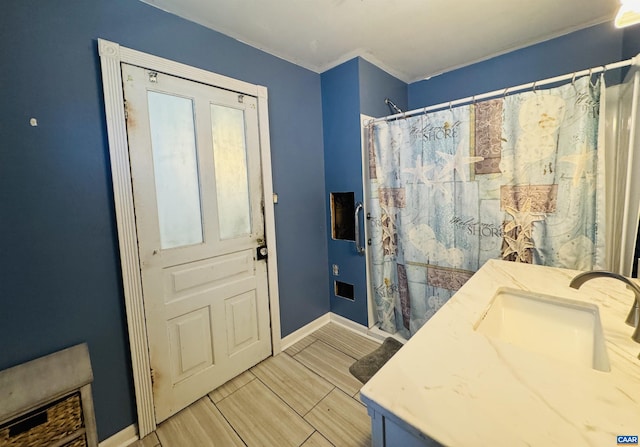 bathroom with vanity, a shower with curtain, and baseboards