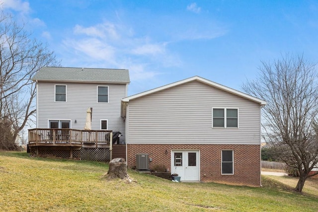 rear view of house with central AC, a lawn, and a wooden deck