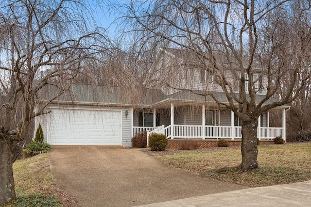 view of front facade with a porch, a front yard, an attached garage, and aphalt driveway