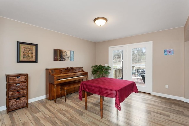 living area with light wood-style floors and baseboards