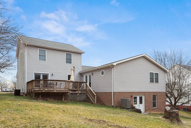 back of house featuring a lawn, a wooden deck, and central air condition unit