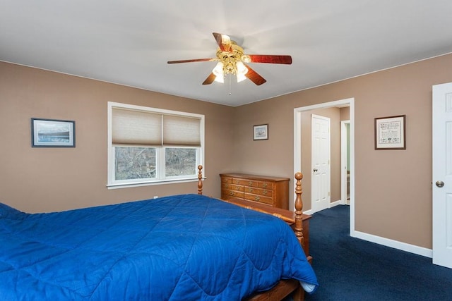 bedroom with baseboards, dark carpet, and ceiling fan