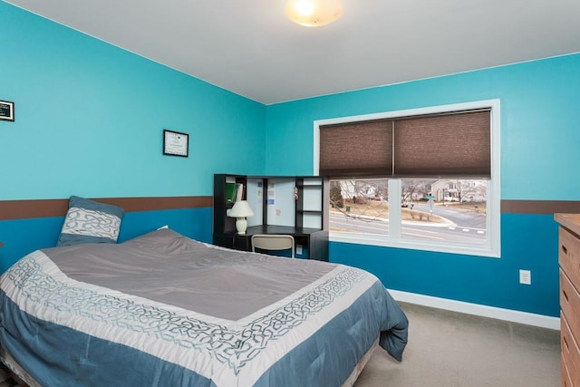 carpeted bedroom featuring baseboards