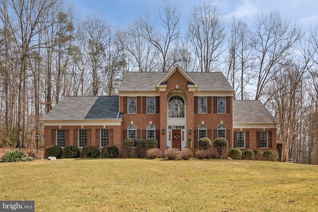 view of front of home featuring a front yard and brick siding