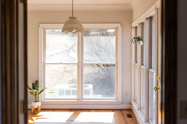 interior space with wood-type flooring and ornamental molding