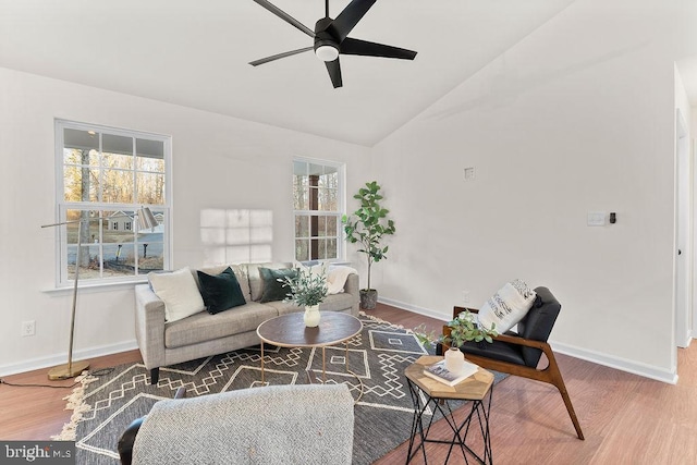 living room featuring hardwood / wood-style flooring, vaulted ceiling, and ceiling fan