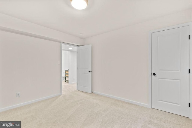 spare room featuring light colored carpet