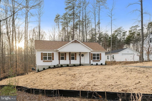 view of front of house with a garage, central AC, and covered porch