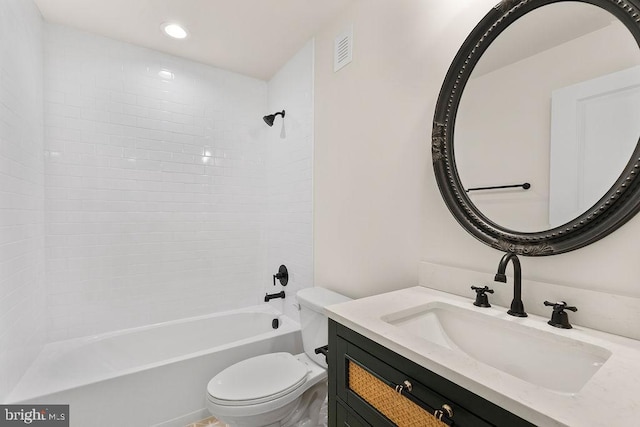 full bathroom featuring vanity, toilet, and tiled shower / bath combo