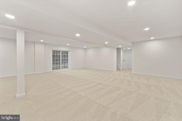 basement featuring light carpet