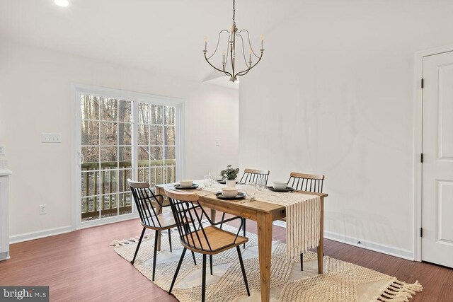 dining room featuring wood-type flooring and a notable chandelier