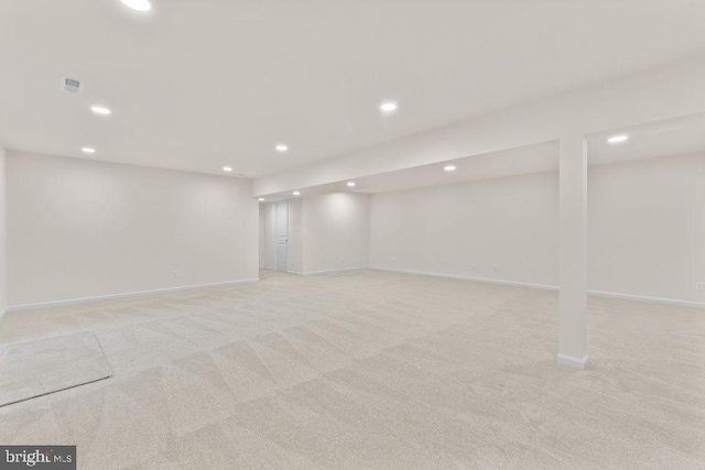 basement featuring light colored carpet