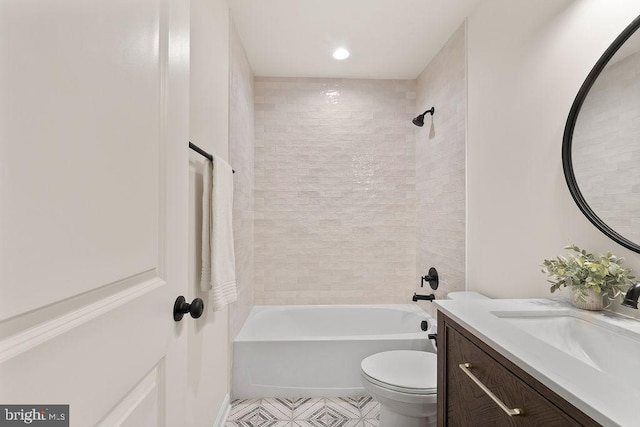 full bathroom with tiled shower / bath combo, vanity, and toilet