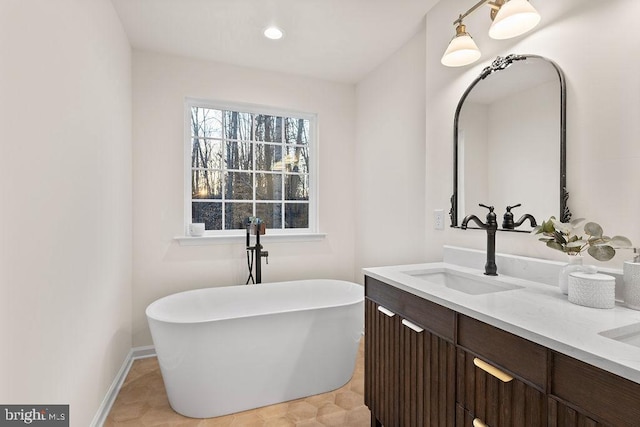 bathroom with vanity and a tub to relax in