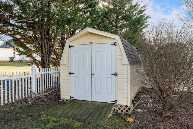 view of shed featuring fence