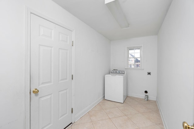 clothes washing area with light tile patterned floors, laundry area, washer / clothes dryer, and baseboards