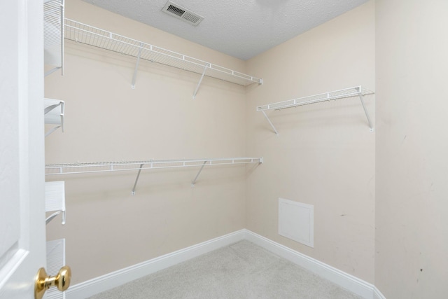 spacious closet featuring carpet and visible vents