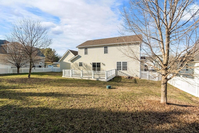 rear view of property with a fenced backyard, a yard, and a wooden deck