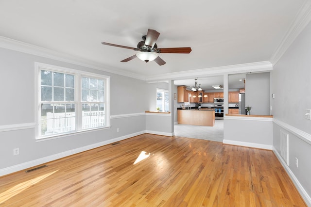 unfurnished living room with baseboards, visible vents, crown molding, light wood-type flooring, and ceiling fan with notable chandelier