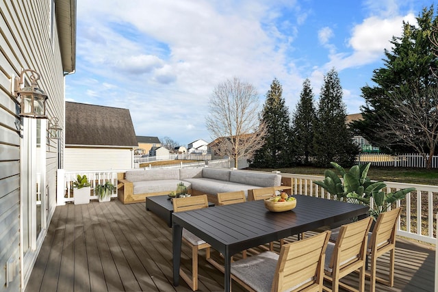 wooden deck featuring outdoor lounge area and fence