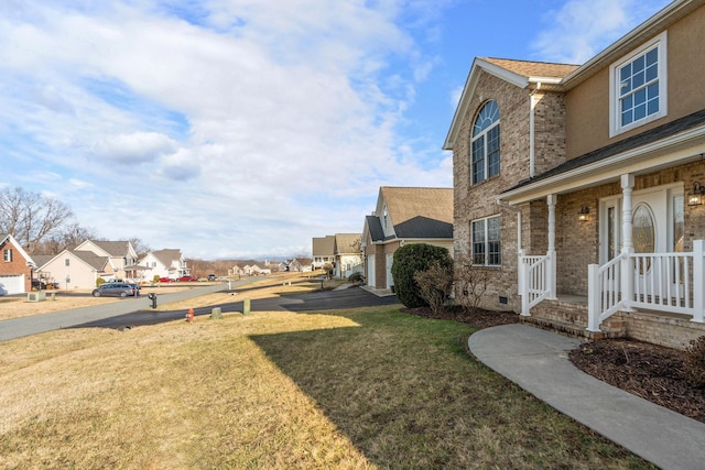 view of yard with a porch and a residential view