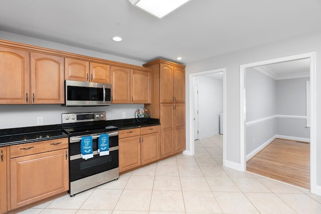 kitchen featuring light tile patterned floors, baseboards, stainless steel appliances, and recessed lighting