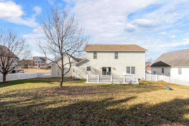 back of property with a fenced backyard and a lawn