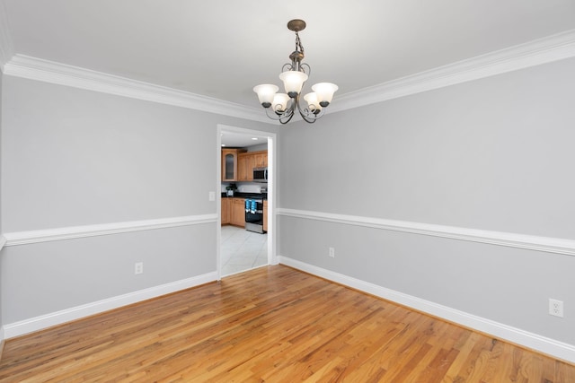 unfurnished dining area featuring light wood finished floors, a chandelier, and ornamental molding