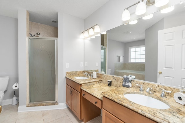 full bath featuring a stall shower, a sink, and toilet