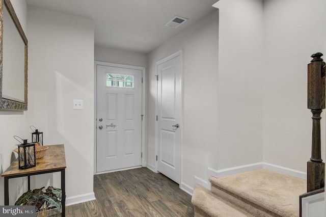 entryway featuring dark wood-type flooring, visible vents, and baseboards