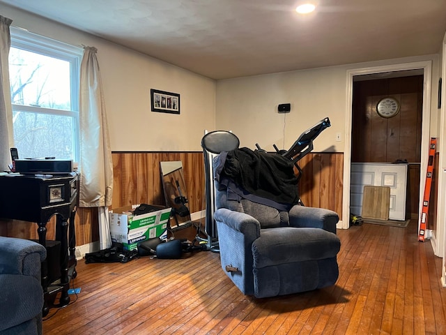 living area with hardwood / wood-style floors and wood walls