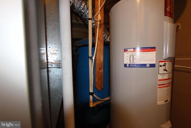 utility room featuring water heater