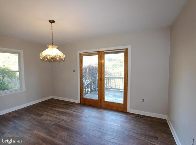 unfurnished room with dark wood-type flooring