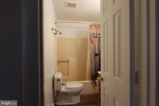 bathroom featuring hardwood / wood-style floors, shower / bath combo, and toilet