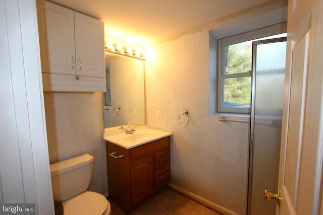 bathroom featuring vanity, tile patterned flooring, and toilet