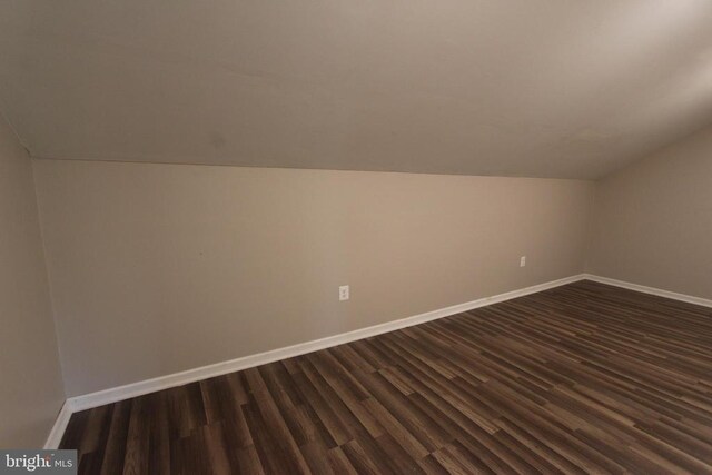 bonus room featuring lofted ceiling and dark hardwood / wood-style flooring