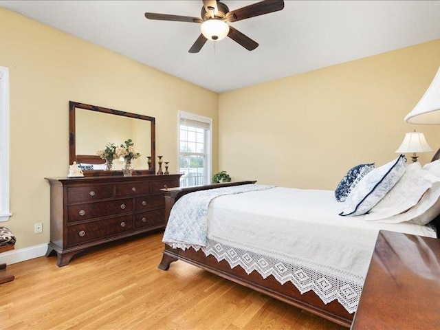 bedroom with light hardwood / wood-style floors and ceiling fan