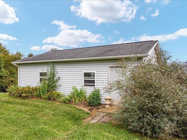 view of side of home featuring a yard