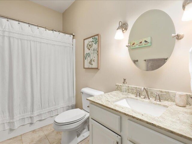 full bathroom with vanity, shower / tub combo, tile patterned floors, and toilet