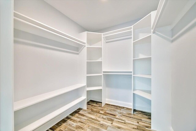 walk in closet featuring hardwood / wood-style flooring