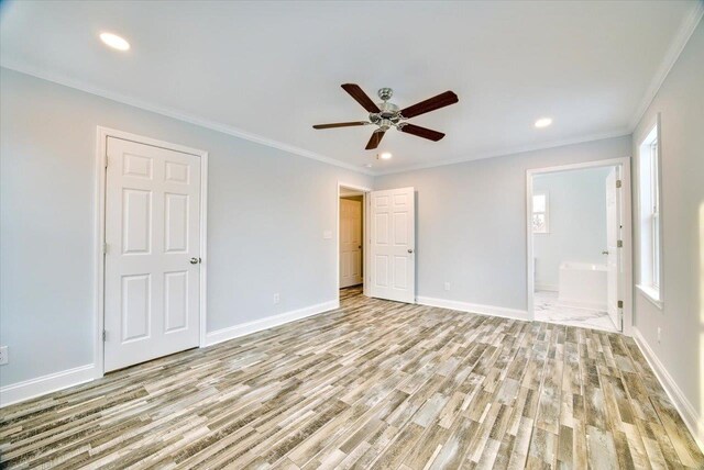 unfurnished bedroom with crown molding, ceiling fan, light wood-type flooring, and ensuite bath