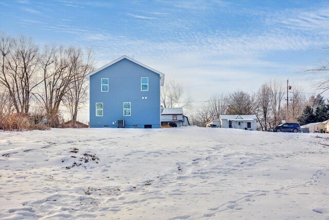 snow covered property featuring cooling unit