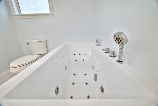 bathroom featuring a bathtub and toilet