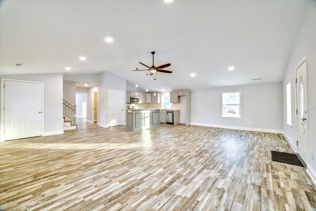 unfurnished living room with ceiling fan, lofted ceiling, and light hardwood / wood-style flooring