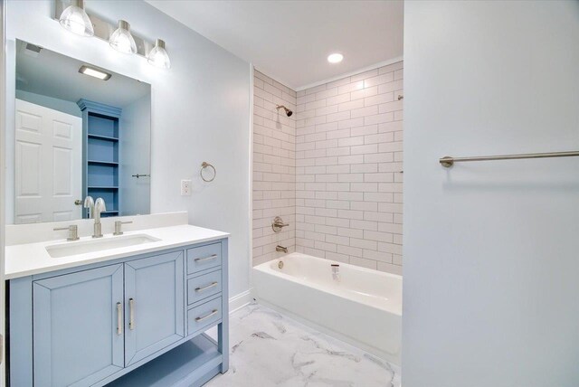 bathroom with vanity and tiled shower / bath combo