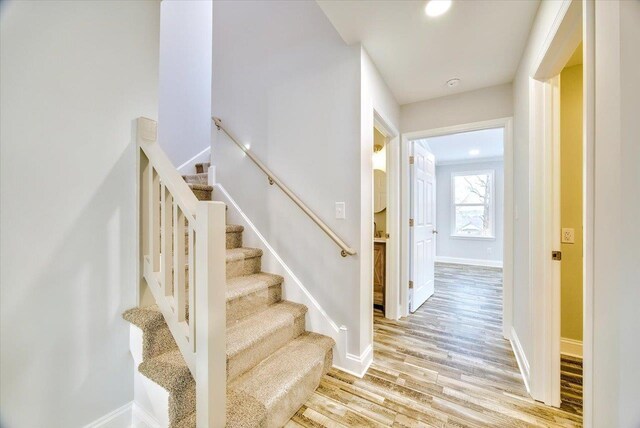 staircase with hardwood / wood-style floors