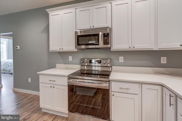 kitchen featuring white cabinetry, light countertops, and appliances with stainless steel finishes