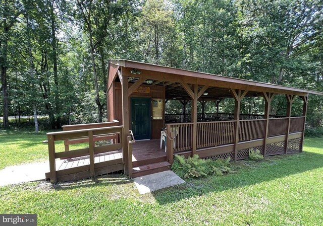 view of community with a lawn and a wooden deck