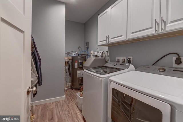 laundry area featuring cabinet space, electric water heater, independent washer and dryer, and light wood-style flooring