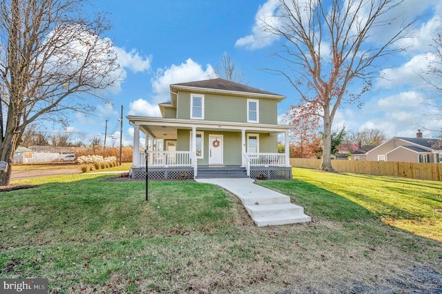 farmhouse-style home featuring a front yard and covered porch